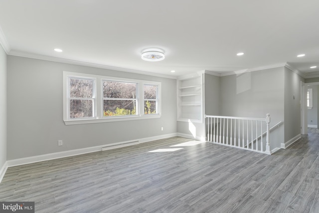 unfurnished room with crown molding and light hardwood / wood-style flooring