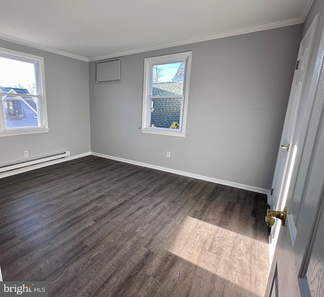 empty room featuring baseboard heating, dark hardwood / wood-style flooring, a healthy amount of sunlight, and ornamental molding