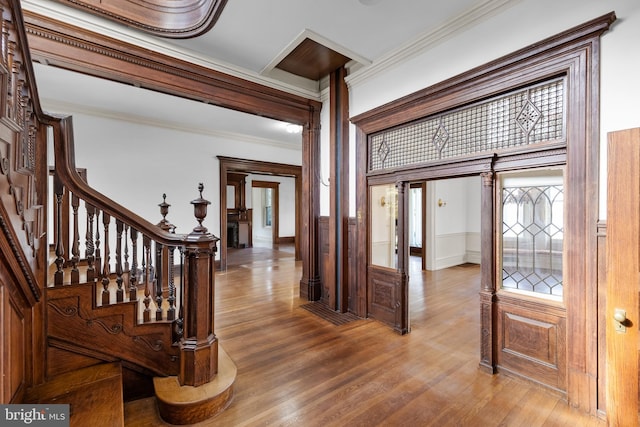 foyer with hardwood / wood-style flooring and ornamental molding