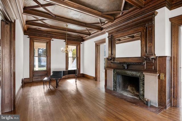 misc room featuring a high end fireplace, an inviting chandelier, ornamental molding, and coffered ceiling