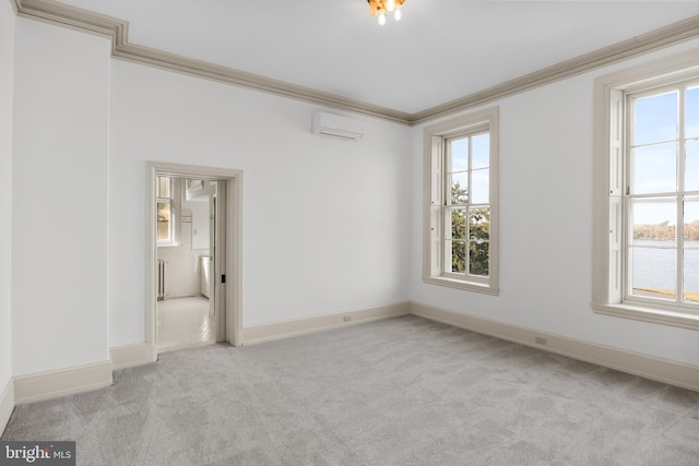 carpeted spare room featuring a wall mounted air conditioner and crown molding