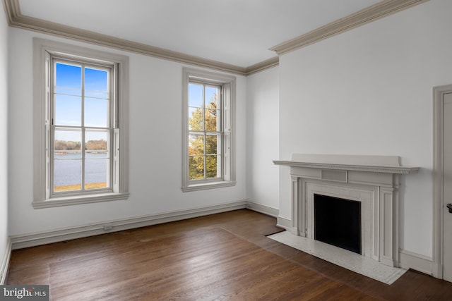 unfurnished living room featuring crown molding, a water view, and dark wood-type flooring