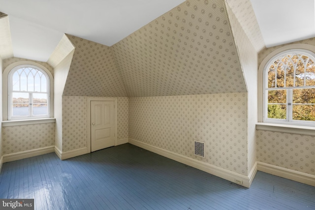 bonus room with dark hardwood / wood-style floors and lofted ceiling