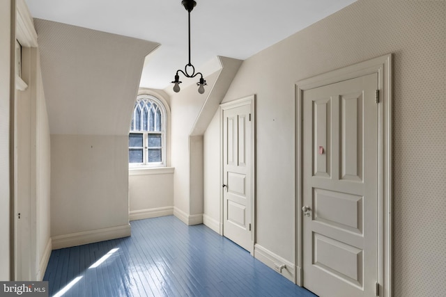 interior space with dark wood-type flooring and lofted ceiling