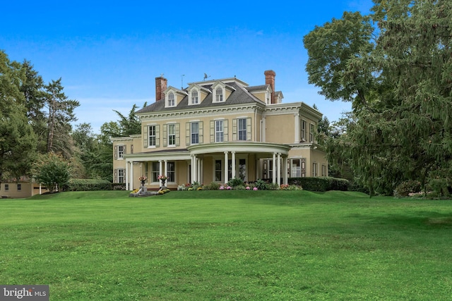 view of front of home with covered porch and a front yard