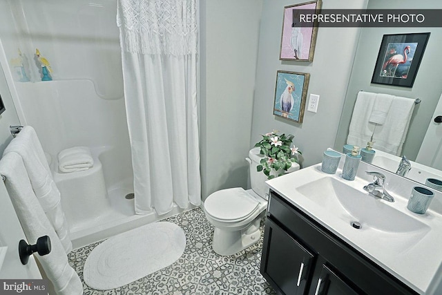 bathroom featuring tile patterned floors, curtained shower, vanity, and toilet