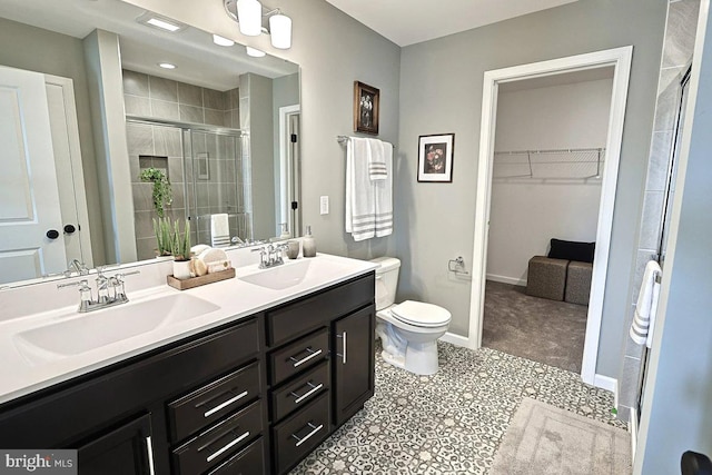 bathroom featuring tile patterned floors, toilet, vanity, and walk in shower