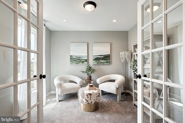 living area with carpet flooring and french doors