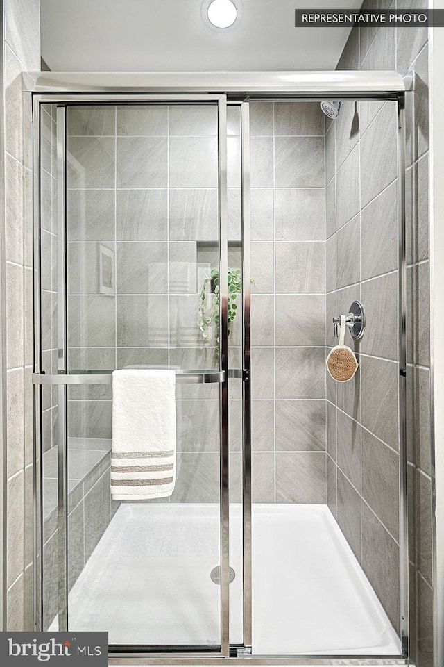 bathroom with a shower with shower door