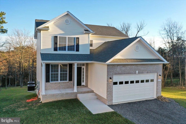 front facade featuring a front yard, a garage, covered porch, and central air condition unit