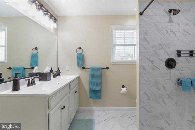 bathroom featuring a tile shower and vanity