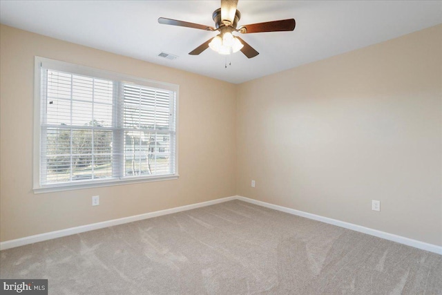 carpeted spare room with ceiling fan