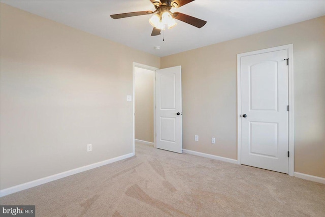 unfurnished bedroom featuring ceiling fan and light colored carpet