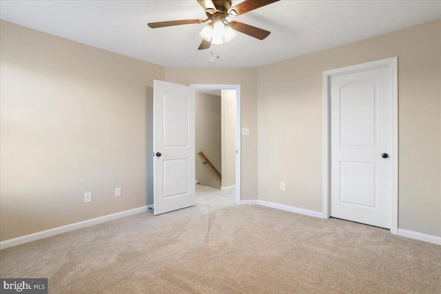 unfurnished bedroom with ceiling fan and light carpet