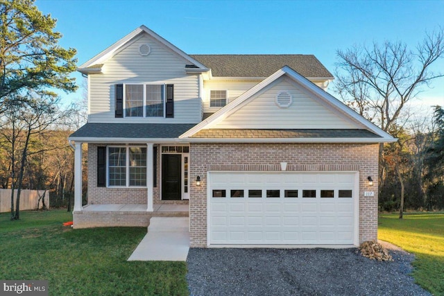 view of front property with a front yard, a garage, and covered porch