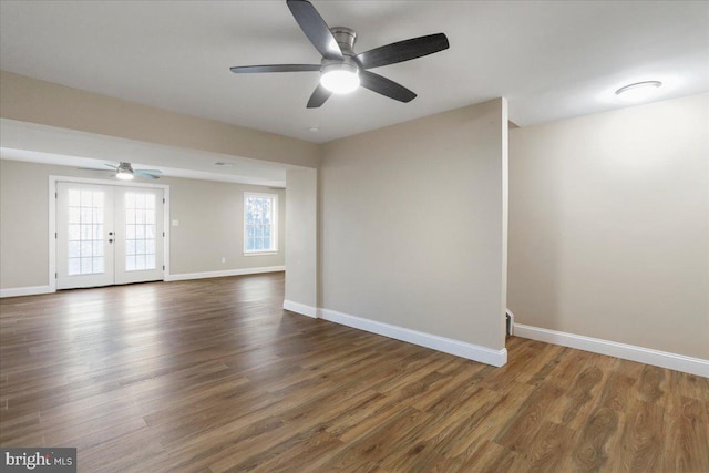 spare room with ceiling fan, dark hardwood / wood-style flooring, and french doors