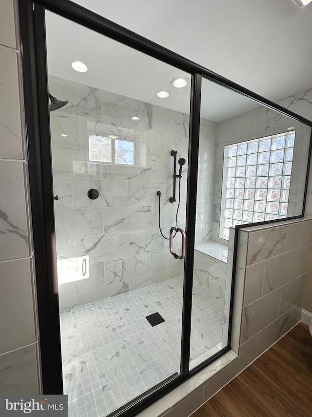 bathroom featuring walk in shower and wood-type flooring