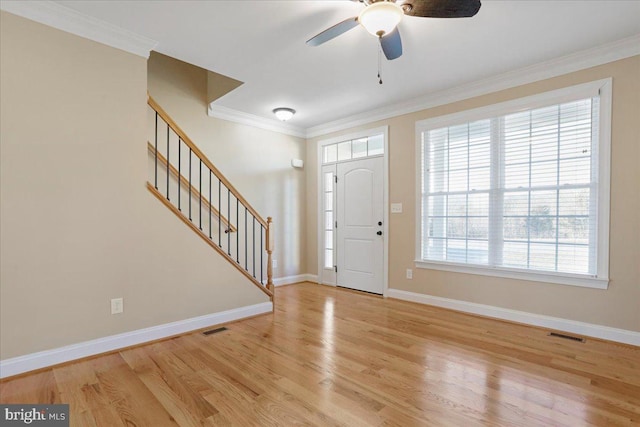 entryway with ceiling fan, light hardwood / wood-style floors, and crown molding