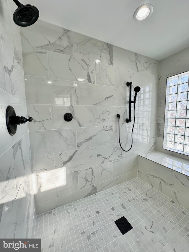 bathroom with a tile shower