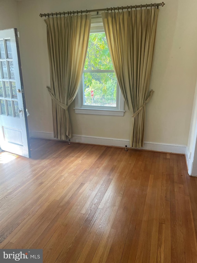 unfurnished room with hardwood / wood-style floors