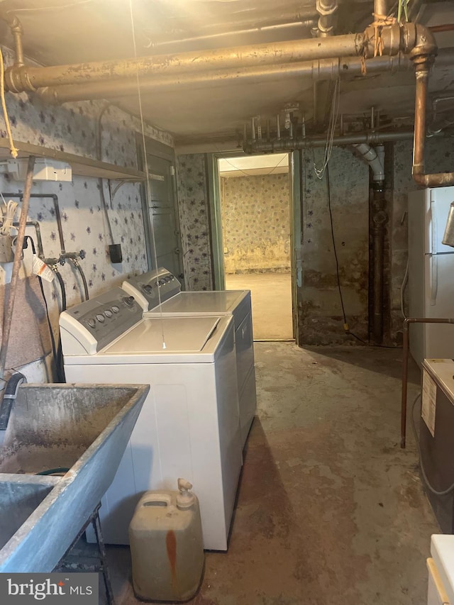 laundry area featuring washer and clothes dryer and sink