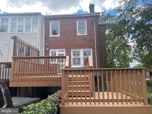 rear view of house featuring a deck