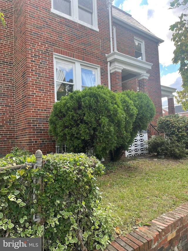 view of side of home featuring a lawn