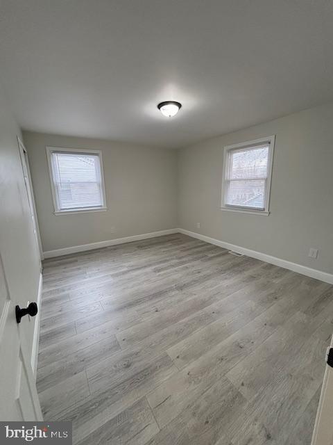 spare room featuring light hardwood / wood-style flooring