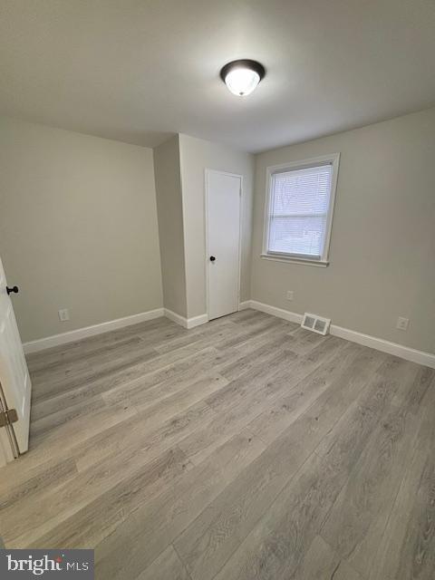 spare room featuring light hardwood / wood-style floors