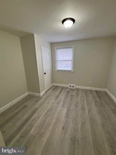 spare room featuring wood-type flooring