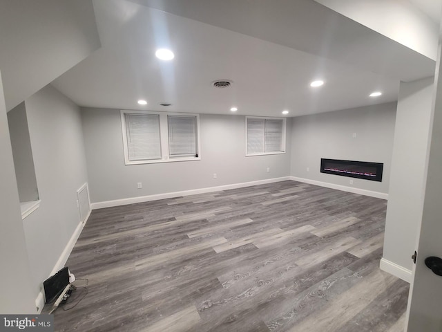 basement with hardwood / wood-style floors