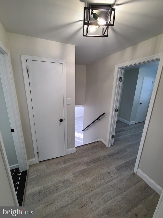 corridor with light hardwood / wood-style floors