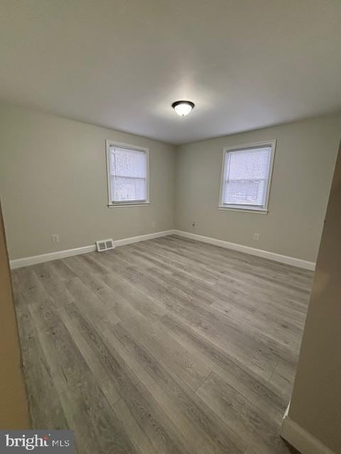 empty room with light hardwood / wood-style flooring