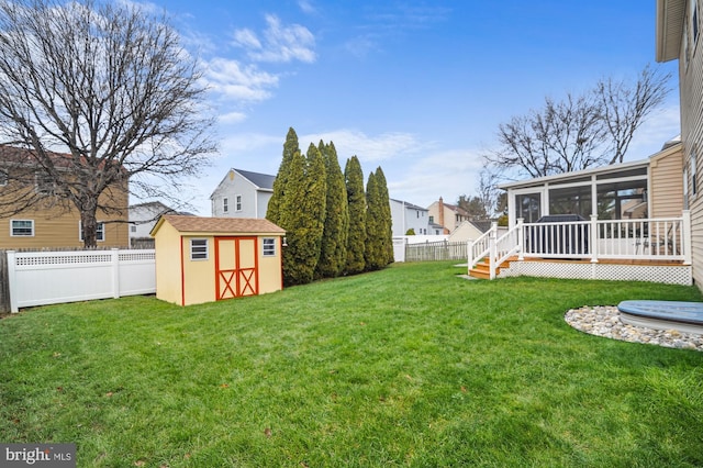 view of yard with a sunroom and a shed