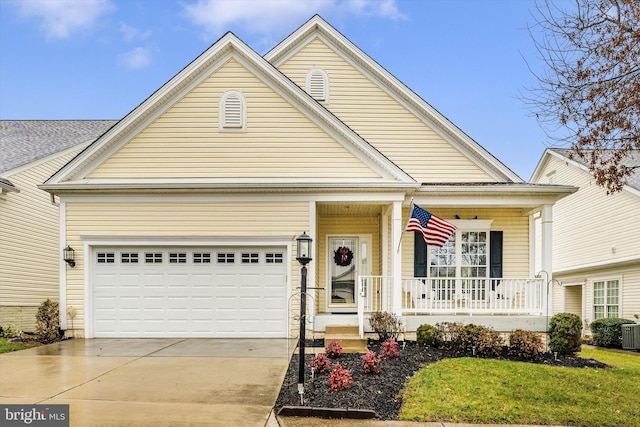 view of front of house with central air condition unit, covered porch, and a garage