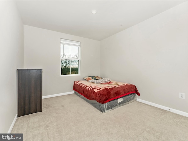 bedroom featuring light colored carpet