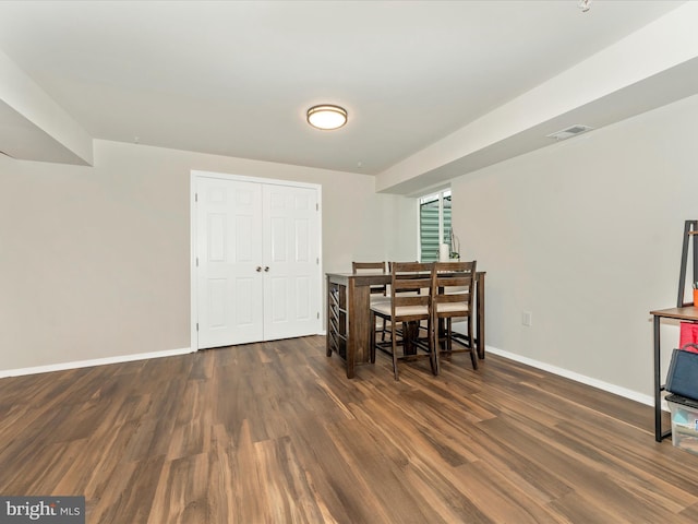 dining space with dark wood-type flooring