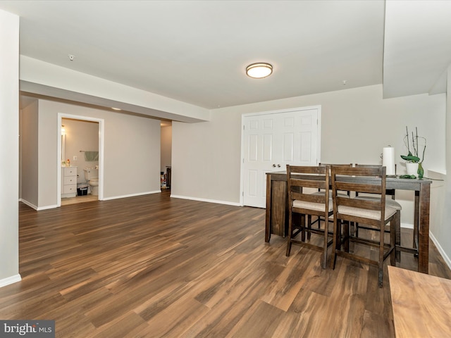 dining space with dark hardwood / wood-style floors