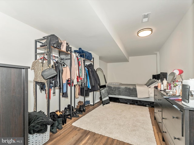 walk in closet featuring hardwood / wood-style floors