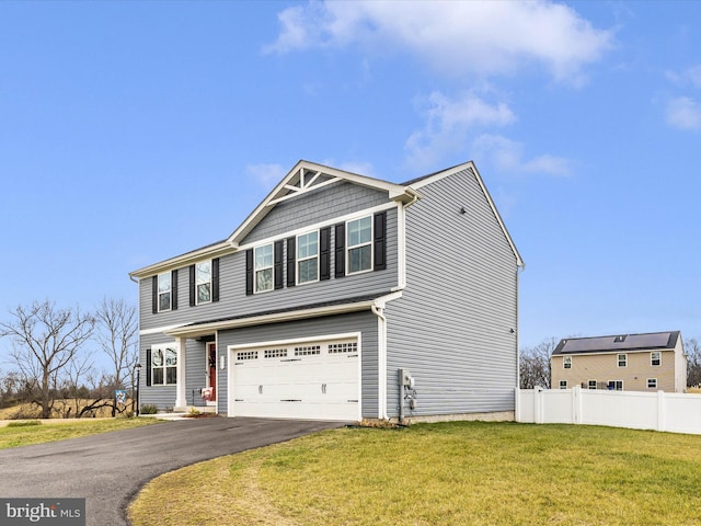 view of front of property featuring a garage and a front lawn