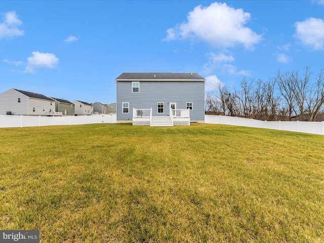 back of house with a yard and a deck