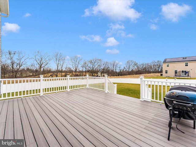 deck featuring a yard and grilling area