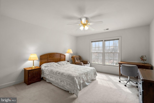 bedroom featuring baseboards, visible vents, ceiling fan, and light colored carpet