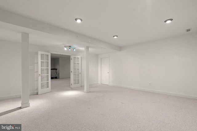 unfurnished room featuring light colored carpet, french doors, visible vents, and baseboards