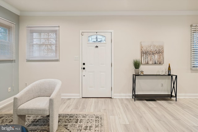 entrance foyer with light hardwood / wood-style floors and ornamental molding