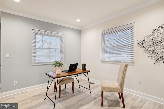 office space with light hardwood / wood-style floors and crown molding