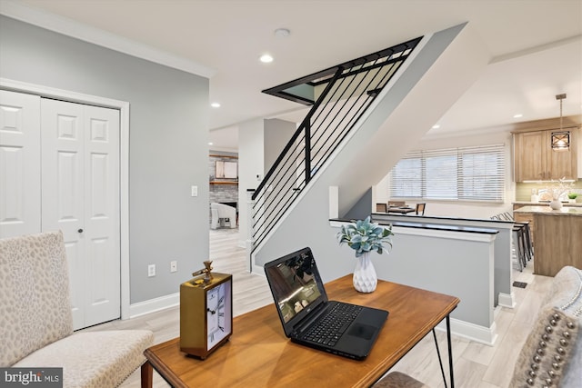 dining area with light hardwood / wood-style floors and ornamental molding