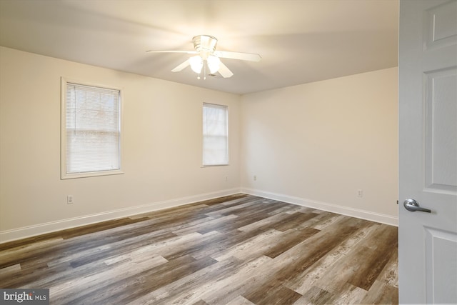 spare room with ceiling fan and dark wood-type flooring