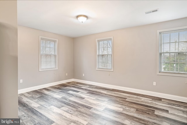 empty room with hardwood / wood-style flooring