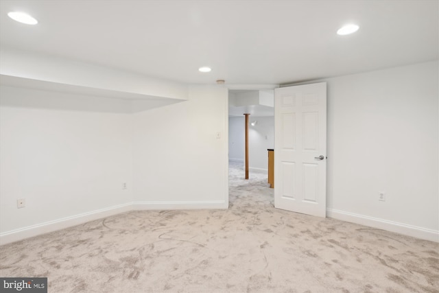 basement featuring light colored carpet